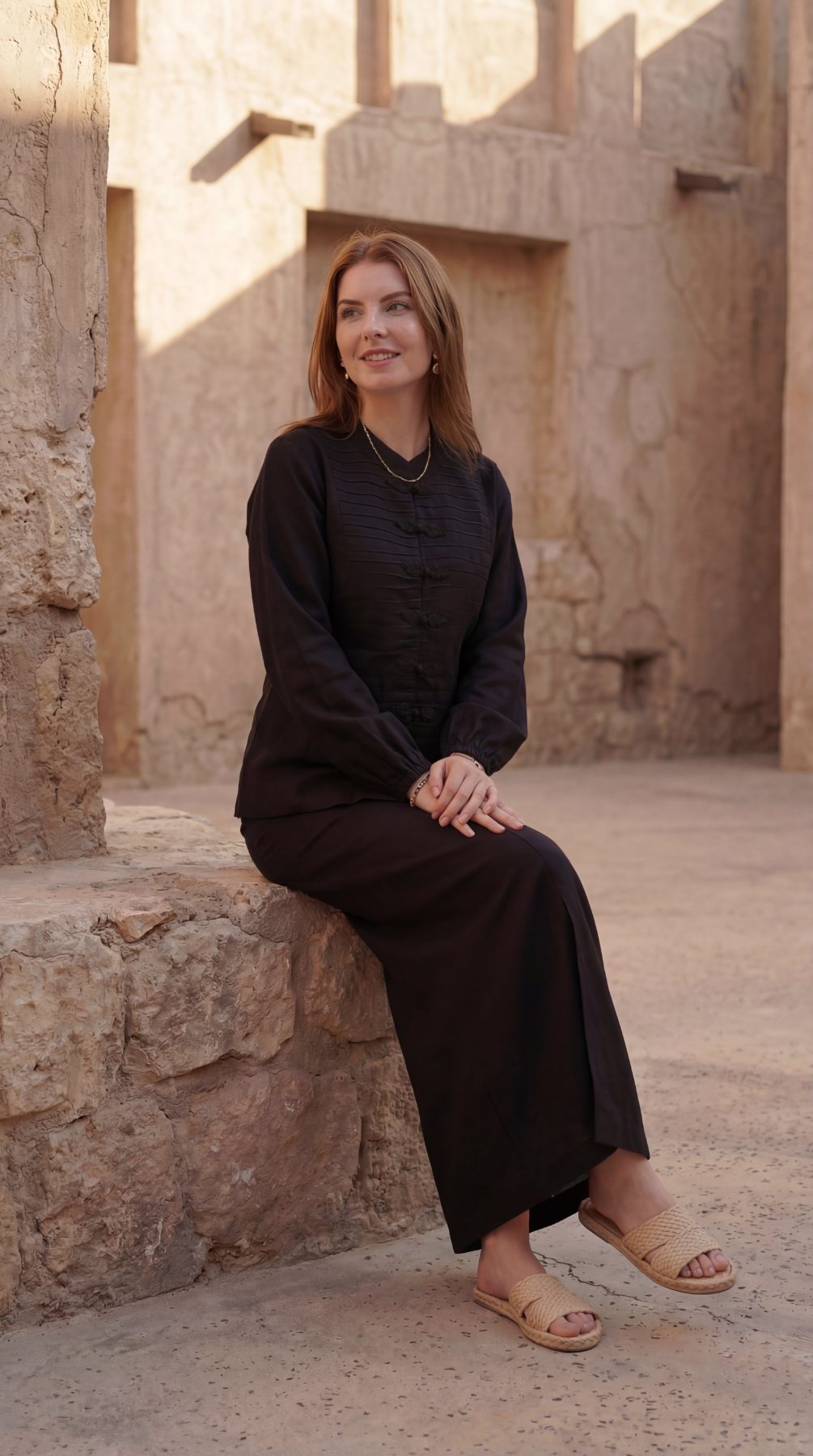 Inori Black Linen Top, black 100% linen mandarin collar blouse with frog-button knots, bell sleeves and adjustable corset-style lace-up back – side view